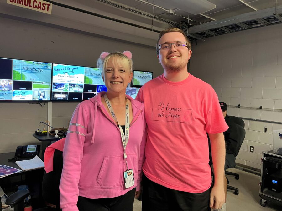 white blonde woman and white male side by side in pink tshirts